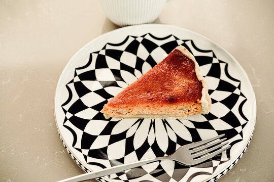 gourmet pear and cheese tart slice on black and white plate