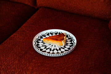cozy alone moment with pear and cheese tart on chesnut brown sofa