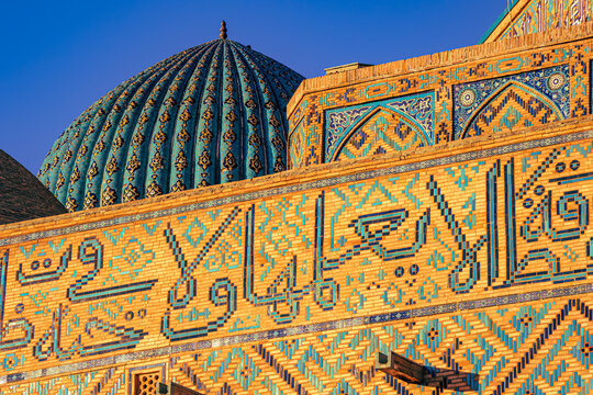 Close-up view of the facade of the incomplete Mausoleum of Khoja Ahmed Yasawi in Turkistan, Kazakhstan, shows its glazed tiles and ornate features