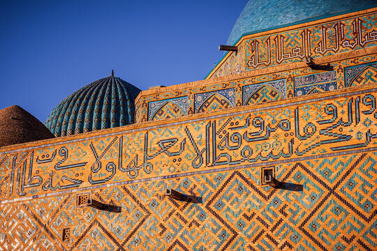 Close-up view of the facade of the incomplete Mausoleum of Khoja Ahmed Yasawi in Turkistan, Kazakhstan, shows its glazed tiles and ornate features