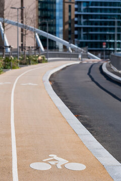 Bicycle lane on a bridge with urban architecture curve and pavement showing transportation across modern paris infrastructure in clear daylight