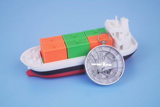 Cargo ship with many containers and broken compass on blue background. Problems with logistics, cargo and sea transportation.