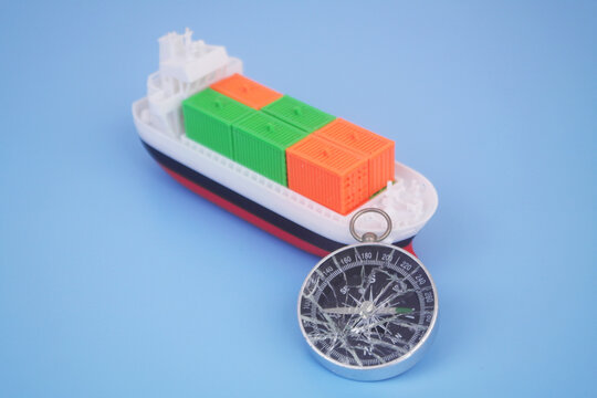 Cargo ship with many containers and broken compass on blue background. Problems with logistics, cargo and sea transportation.