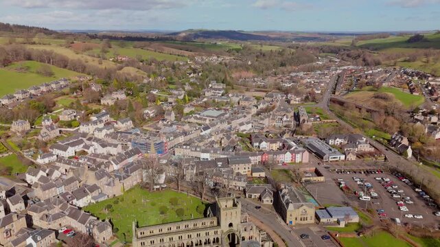 Drone view of Jedburgh, Scottish Borders buildings and hills on a sunny day