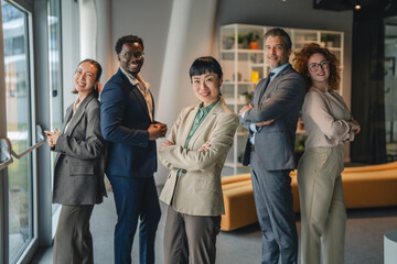 Fototapeta premium Diverse business team standing confident in modern office