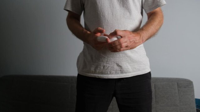 Caucasian man's hands wrapping medical gauze around an injured finger after an accident