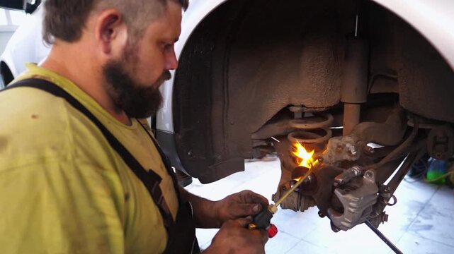 Skilled automotive technician performing intricate repairs on a vehicle in a garage, utilizing specialized tools and techniques to ensure optimal performance and safety in the automotive service
