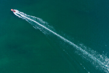 Speedboat leaving a foamy white trail on blue ocean The Concept of speed © VicVaz