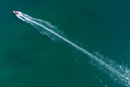 Speedboat leaving a foamy white trail on blue ocean The Concept of speed