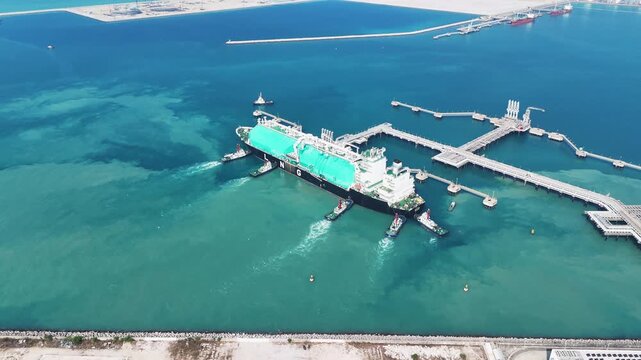 Massive LNG tanker ship assisted by tugboats docking at maritime terminal. Global energy logistics, liquid cargo container supply chain, and natural gas freight transport concept.	