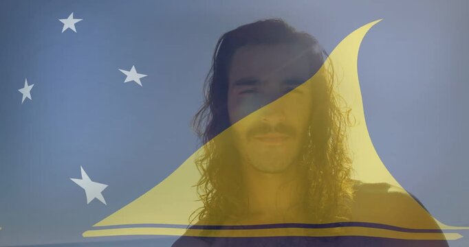 Man facing camera squinting from sun glare, yellow sail graphic shifting over face for marketing