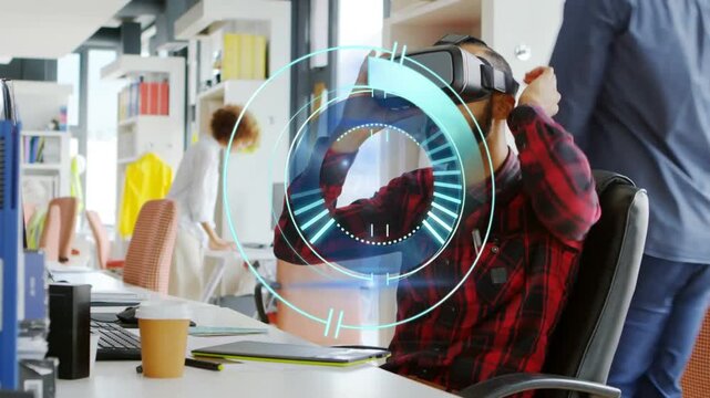 Man at desk reaching for VR headset, donning and gesturing at circular hologram UI for business