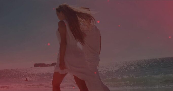 Couple walking travel shore, man moving closer and taking hand, red specks glowing, sharing love