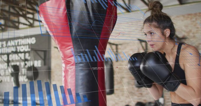 Woman boxer shifting weight, stepping in and punching heavy bag while blue graphs tracking metrics