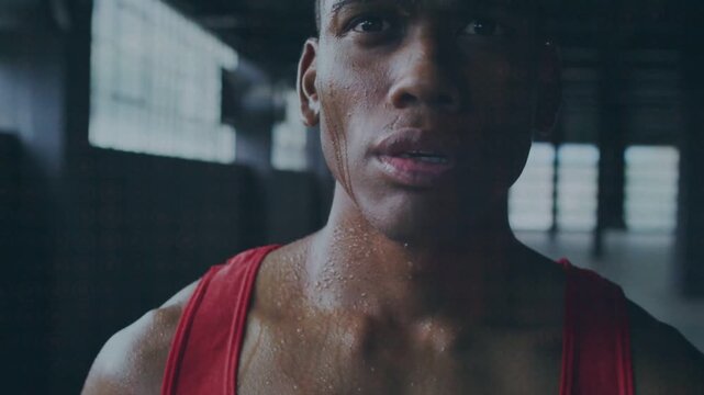 Camera pulling back showing athlete training in gym, red tank top sweat glistening, scar emerging