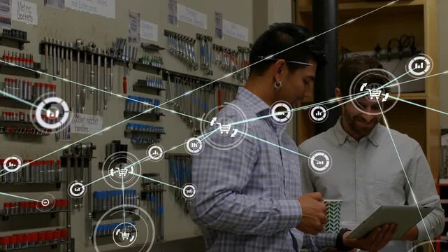 Two men studying tablet in workshop, right man tapping, HUD expanding and visualizing sales data