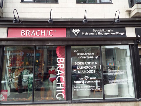 Ottawa, Ontario, Canada &ndash; July 23, 2025: An urban storefront in Westboro features "IRIS optometry and Aseer Time" dessert shop signage at 438 Richmond Road.