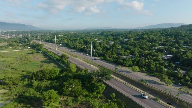 Aerial view of highway through farmland in Cortes, Honduras, rural landscape, logistics infrastructure