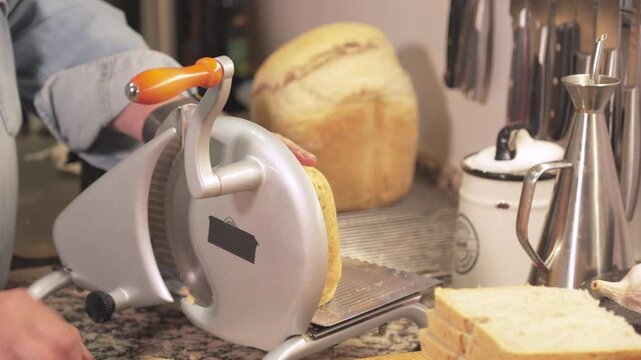 Cutting bread in kitchen