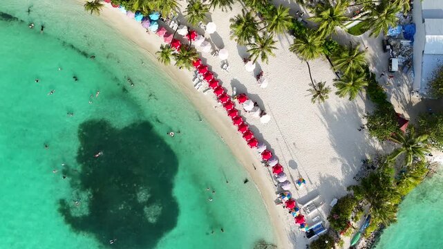 Top Down Aerial of Red Beach Umbrellas on Maafushi Island Maldives