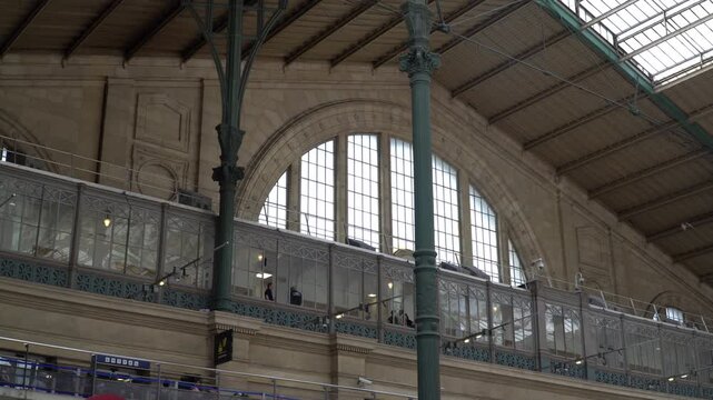 Interior of the Gare de Lyon railway station in Paris, France. Green iron columns and vaulted ceiling.
