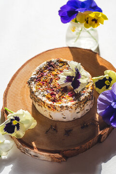 Floral spring cheese, a dietary product. Spring Easter menu. Unusual farm cheeses. Sunny mood, front view