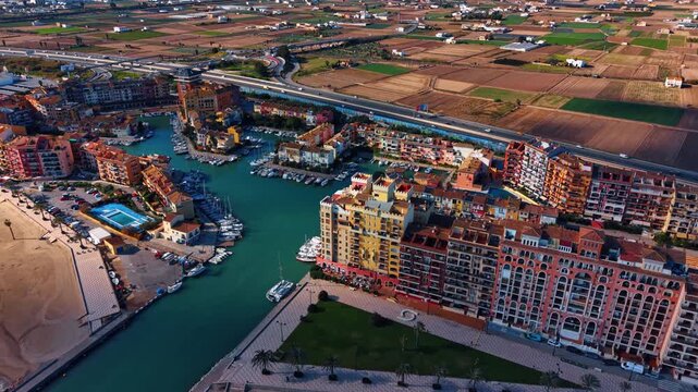 Scenic view on the beautiful Port Saplaya, Valencia, Spain. Little Venice complemented by golden-sand Mediterranean beaches. Aerial view.