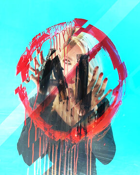 An artist woman is against Artificial Intelligence with an Anti-AI symbol Painted on Glass for a statement against the new technology.