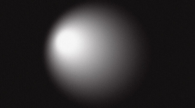 Abstract grainy spotlight effect on a dark black background with noise