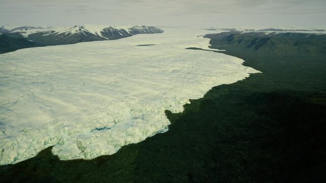 Survey flight over Greenland glacier showing melting terminus and ice calving, scientific mission mood with instrumentation and monitoring context.