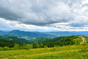 Fototapeta premium Winding Dirt Road on a Green Mountain Ridge