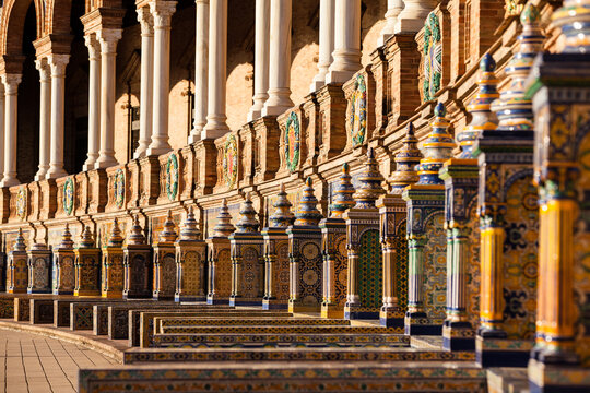Close-up low angle view of a Series of tiled Provincial Alcoves, Azulejos, along the curved perimeter of Plaza de Espa&ntilde;a, Seville, Spain