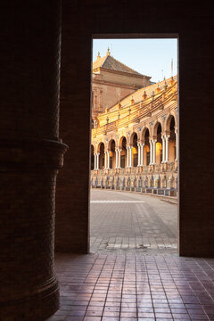 Framed architectural view of the Plaza de Espa&ntilde;a through a stone doorway. Seville, Spain