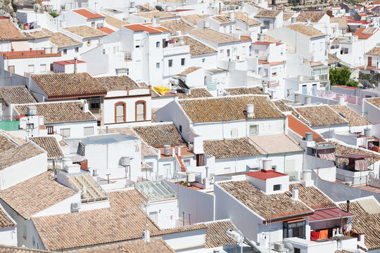 Overhead view of terracotta rooftops in the white village of Olvera, Spain
