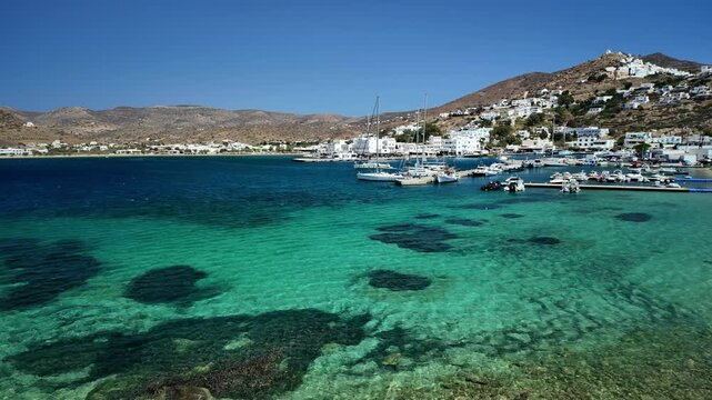 Panoramic view of the port of Ios Greece surrounded by turquoise clear water
