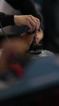 Instructor guiding trainee hand on flight simulator joystick