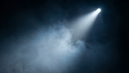 Fototapeta premium A spotlight shines brightly through smoke in a dark room with a beam of light.