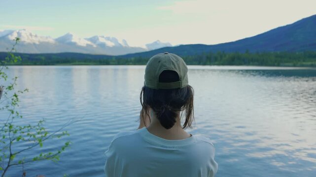 Woman capturing Pyramid Lake scenery in Jasper National Park, Canada