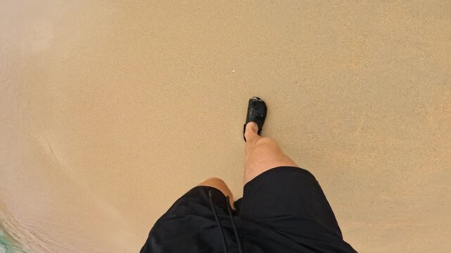 First person view walking on soft beach sand with casual summer footwear
