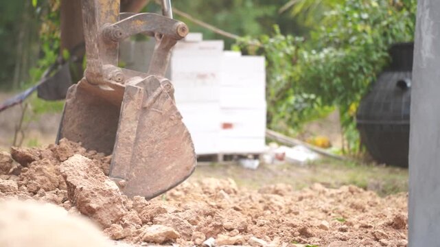 Construction Site Excavation: A close-up view captures the powerful scoop of an excavator as it digs into the earth, highlighting the raw energy of the construction process.