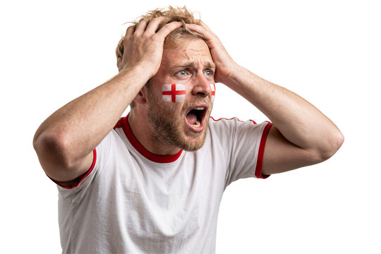 Stressed England football fan with face paint holding head in despair