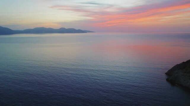 Soft sunset colors over calm Ionian Sea near Kefalonia island in Greece in evening