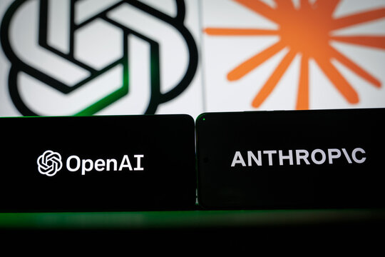 Logos of AI companies OpenAI and Anthropic displayed on smartphone screens, representing the competition in generative artificial intelligence, large language models, and tech industry rivalry.