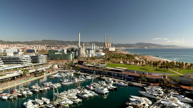 aerial view of barcelona coastline from parc del forum, with view of badalona and tres ximeneas mediterranean sea on a sunny day, modern urban architecture