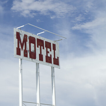 Vintage Motel Sign Against Blue Sky