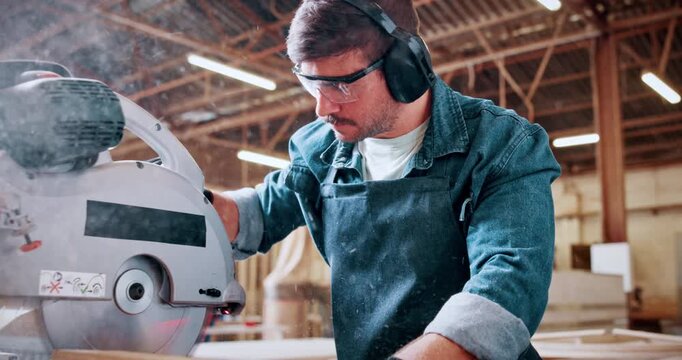 Bandsaw, carpentry and earmuffs with man in warehouse for manufacturing or production process. Eyewear, ppe and sawing machine with person in woodworking plant to resize lumber or timber for project