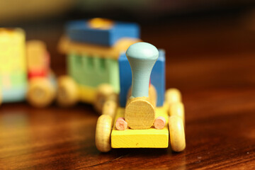 Colorful Vintage Wooden Toy Train on Warm Wooden Surface
