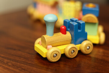 Colorful Vintage Wooden Toy Train on Warm Wooden Surface