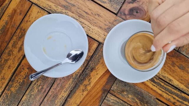Drinking a typical Spanish Coffee with milk (cortado) outdors in a restaurant