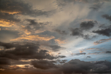 Obraz premium Dark Dramatic Clouds Illuminated by Sunset Light